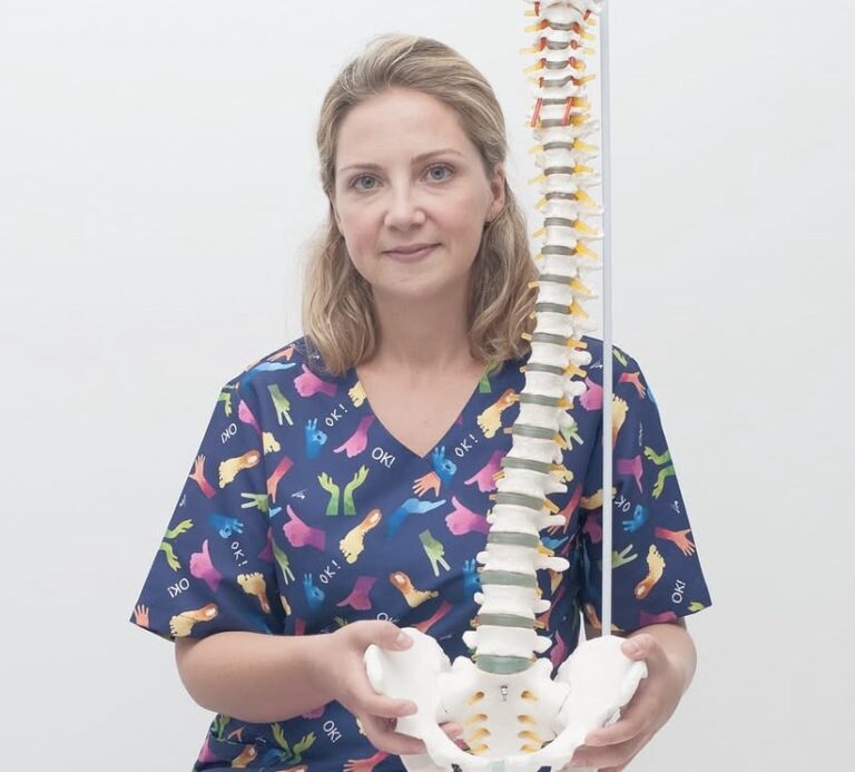 Fisioterapeuta sosteniendo modelo anatómico de columna